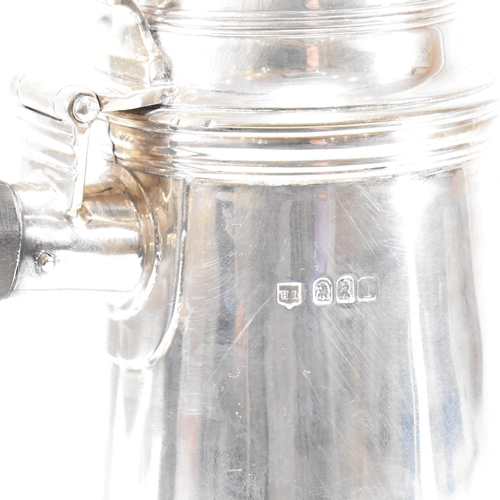 129 - An Edwardian hallmarked Britannia silver coffee pot. The Edward VII pot having a hinged lid, finial ... 