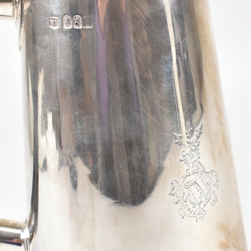 129 - An Edwardian hallmarked Britannia silver coffee pot. The Edward VII pot having a hinged lid, finial ... 