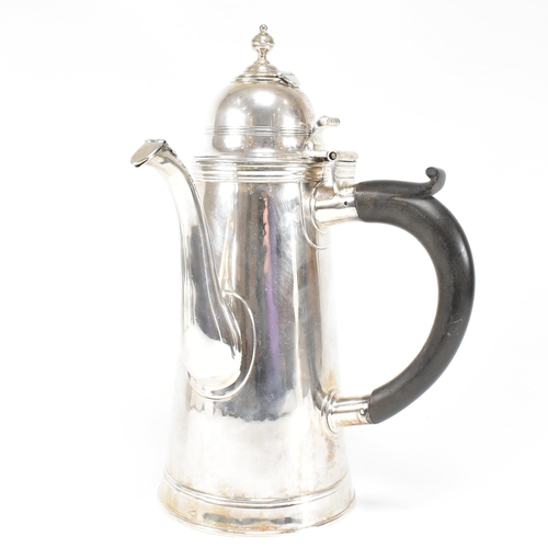 129 - An Edwardian hallmarked Britannia silver coffee pot. The Edward VII pot having a hinged lid, finial ... 