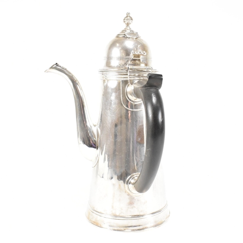 129 - An Edwardian hallmarked Britannia silver coffee pot. The Edward VII pot having a hinged lid, finial ... 