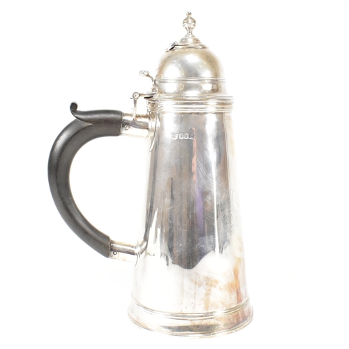 129 - An Edwardian hallmarked Britannia silver coffee pot. The Edward VII pot having a hinged lid, finial ... 