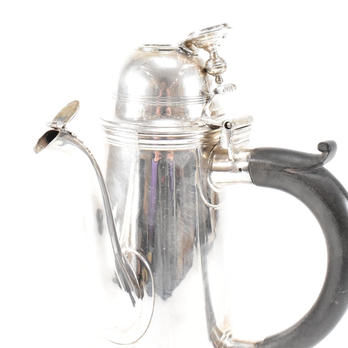 129 - An Edwardian hallmarked Britannia silver coffee pot. The Edward VII pot having a hinged lid, finial ... 