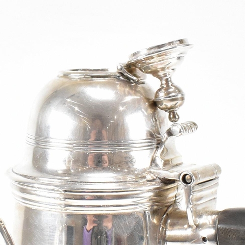 129 - An Edwardian hallmarked Britannia silver coffee pot. The Edward VII pot having a hinged lid, finial ... 