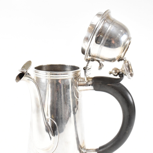 129 - An Edwardian hallmarked Britannia silver coffee pot. The Edward VII pot having a hinged lid, finial ... 