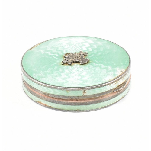 134 - A 1920s hallmarked silver and guilloche enamel compact. The compact having import marks for London 1... 