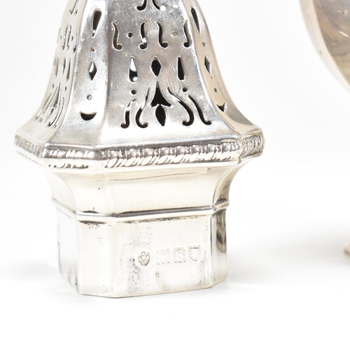 139 - A George V hallmarked silver sugar caster. The caster sitting on a plinth base with repousse decorat... 