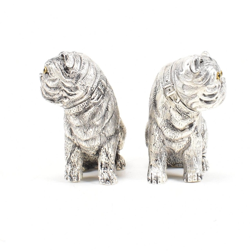 140 - An 800 silver novelty cruet set. The salt and pepper shakers being in the form of English bulldog do... 