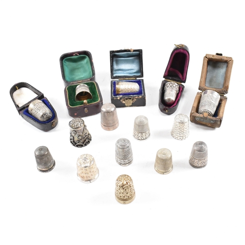 141 - A collection of fifteen hallmarked silver and white metal thimbles with five fitted cases. The lot t... 