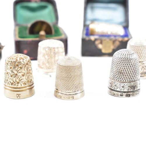 141 - A collection of fifteen hallmarked silver and white metal thimbles with five fitted cases. The lot t... 