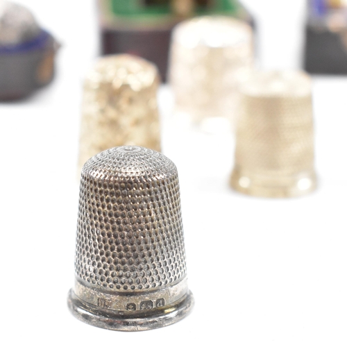 141 - A collection of fifteen hallmarked silver and white metal thimbles with five fitted cases. The lot t... 