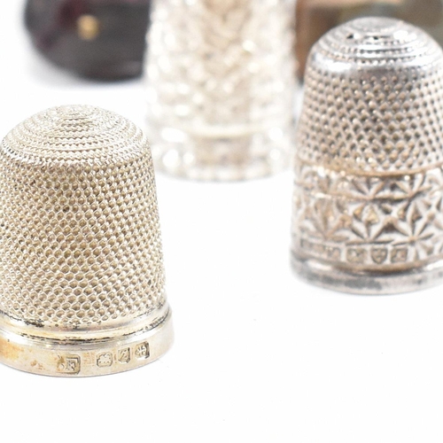 141 - A collection of fifteen hallmarked silver and white metal thimbles with five fitted cases. The lot t... 