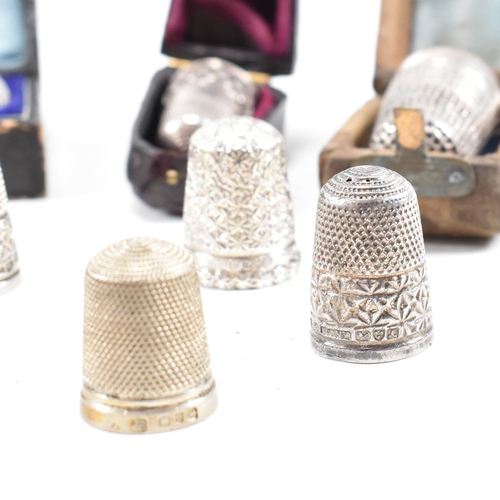 141 - A collection of fifteen hallmarked silver and white metal thimbles with five fitted cases. The lot t... 