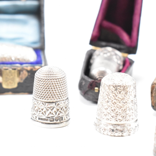 141 - A collection of fifteen hallmarked silver and white metal thimbles with five fitted cases. The lot t... 