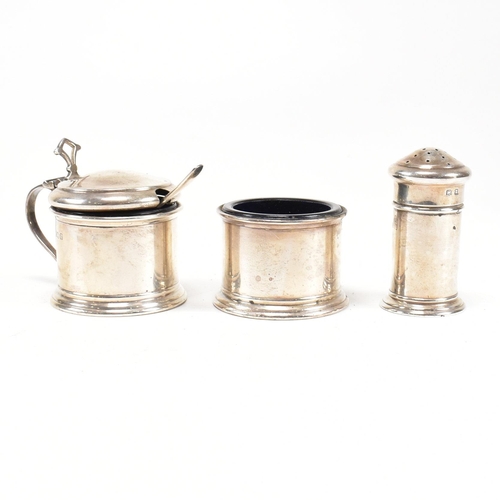 144 - A 1920's hallmarked silver cruet set. The George V three piece set consisting of a salt dish, pepper... 