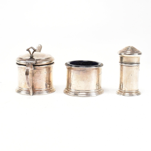 144 - A 1920's hallmarked silver cruet set. The George V three piece set consisting of a salt dish, pepper... 