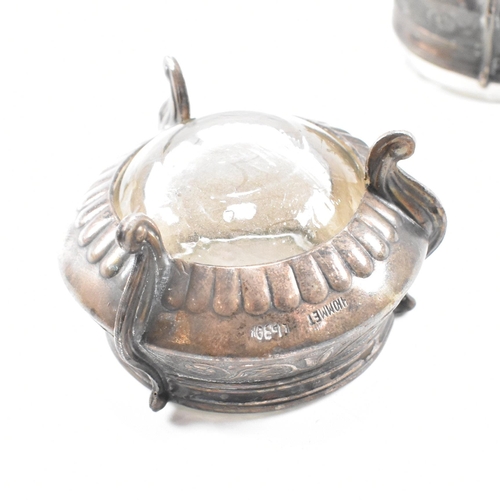 146 - Two Russian white metal salts caviar pots. The pots having repousse decorated body with glass liner ... 