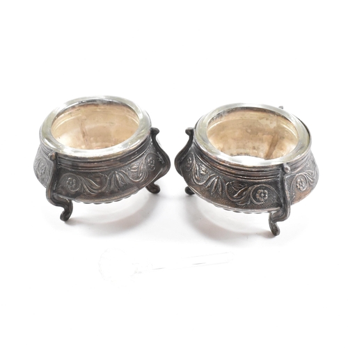 146 - Two Russian white metal salts caviar pots. The pots having repousse decorated body with glass liner ... 