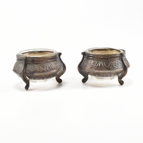 146 - Two Russian white metal salts caviar pots. The pots having repousse decorated body with glass liner ... 