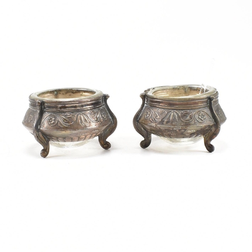 146 - Two Russian white metal salts caviar pots. The pots having repousse decorated body with glass liner ... 