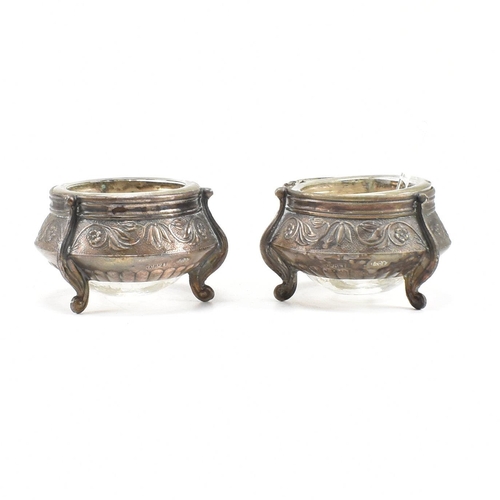 146 - Two Russian white metal salts caviar pots. The pots having repousse decorated body with glass liner ... 