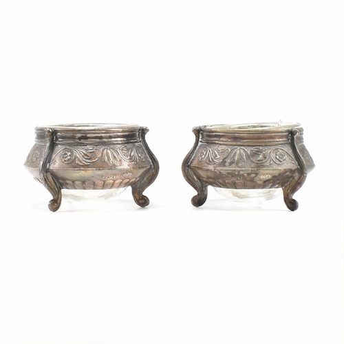 146 - Two Russian white metal salts caviar pots. The pots having repousse decorated body with glass liner ... 