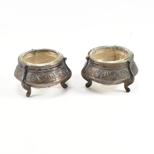 146 - Two Russian white metal salts caviar pots. The pots having repousse decorated body with glass liner ... 