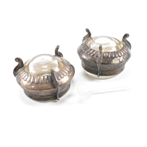 146 - Two Russian white metal salts caviar pots. The pots having repousse decorated body with glass liner ... 