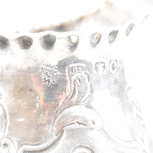 15 - A George III hallmarked silver creamer. The creamer or jug having a circular plinth base rising to a... 