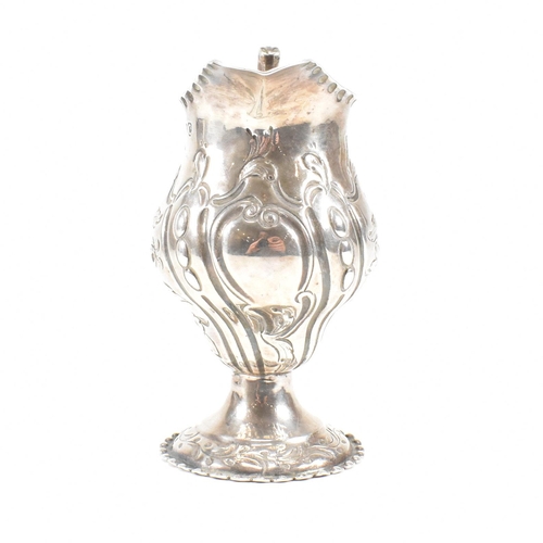 15 - A George III hallmarked silver creamer. The creamer or jug having a circular plinth base rising to a... 