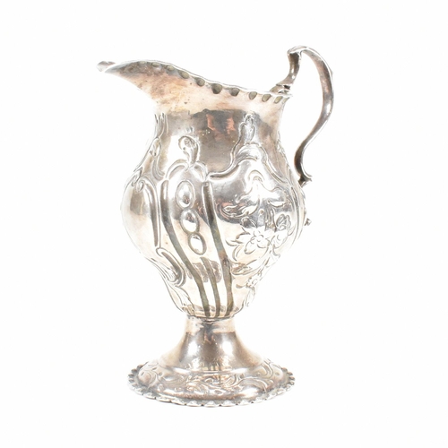 15 - A George III hallmarked silver creamer. The creamer or jug having a circular plinth base rising to a... 