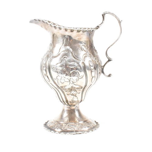 15 - A George III hallmarked silver creamer. The creamer or jug having a circular plinth base rising to a... 