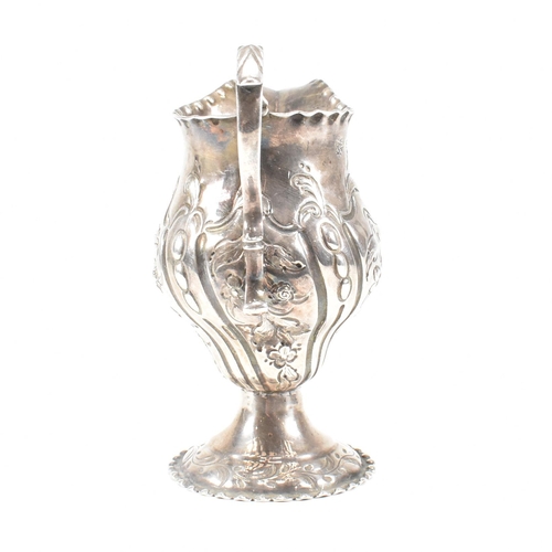 15 - A George III hallmarked silver creamer. The creamer or jug having a circular plinth base rising to a... 