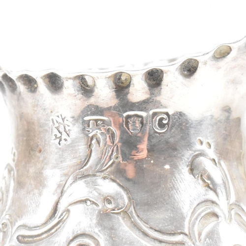 15 - A George III hallmarked silver creamer. The creamer or jug having a circular plinth base rising to a... 