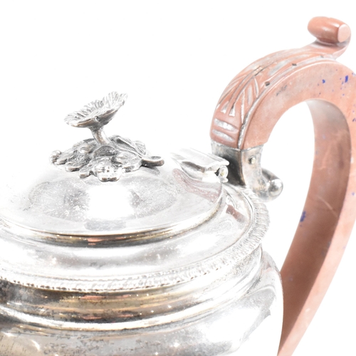 16 - A 1950s hallmarked silver coffee and tea pot set. The pair both standing on four hoof feet with scro... 