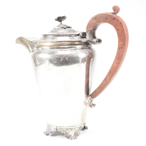 16 - A 1950s hallmarked silver coffee and tea pot set. The pair both standing on four hoof feet with scro... 