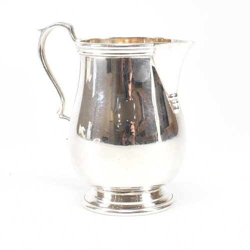 160 - A 1970s hallmarked silver sparrow beak creamer jug. The jug on a circular foot rising to baluster bo... 