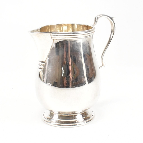 160 - A 1970s hallmarked silver sparrow beak creamer jug. The jug on a circular foot rising to baluster bo... 