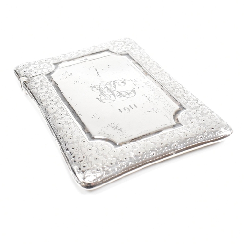 162 - An Edward VII hallmarked silver card case. The Edwardian case having an etched floral boarder design... 