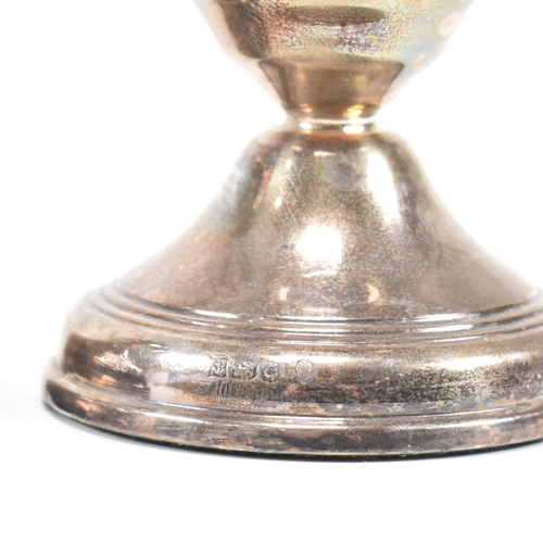 165 - A pair of contemporary hallmarked silver squat candlestick holders. The candlesticks having a weight... 