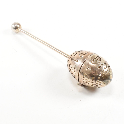 167 - A Victorian hallmarked silver tea infuser of egg form.The infuser having an egg shaped pierced infus... 