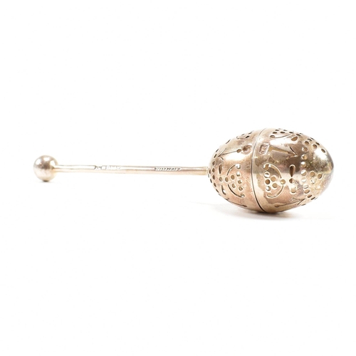 167 - A Victorian hallmarked silver tea infuser of egg form.The infuser having an egg shaped pierced infus... 