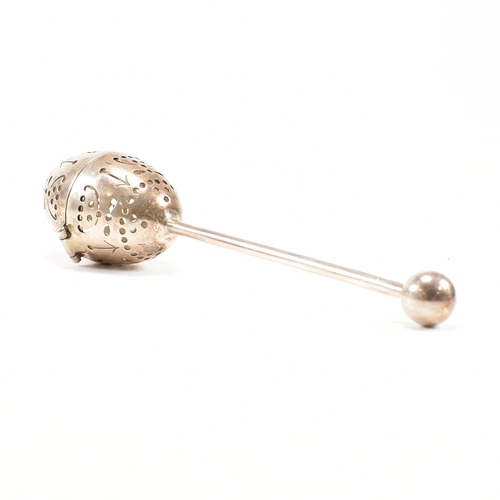 167 - A Victorian hallmarked silver tea infuser of egg form.The infuser having an egg shaped pierced infus... 