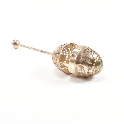 167 - A Victorian hallmarked silver tea infuser of egg form.The infuser having an egg shaped pierced infus... 