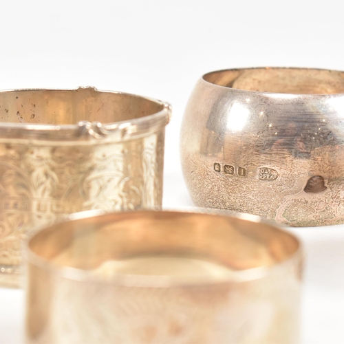 170 - A collection of eight hallmarked silver napkin rings. The lot to include a pair with etched scrolled... 