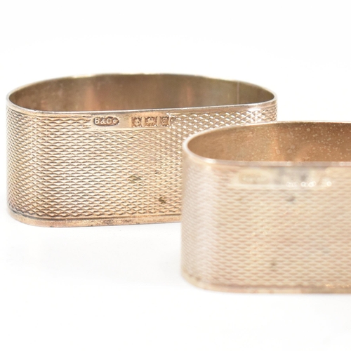 170 - A collection of eight hallmarked silver napkin rings. The lot to include a pair with etched scrolled... 