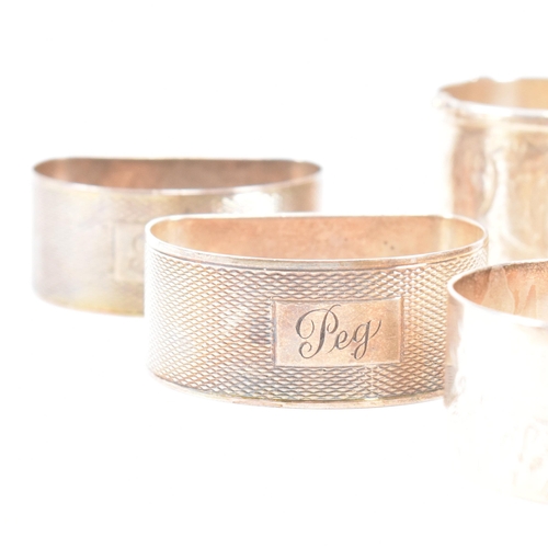 170 - A collection of eight hallmarked silver napkin rings. The lot to include a pair with etched scrolled... 