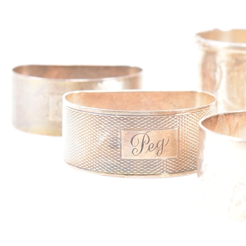 170 - A collection of eight hallmarked silver napkin rings. The lot to include a pair with etched scrolled... 