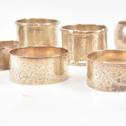 170 - A collection of eight hallmarked silver napkin rings. The lot to include a pair with etched scrolled... 