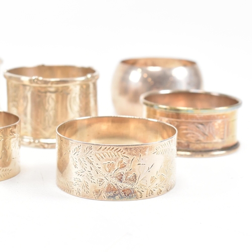 170 - A collection of eight hallmarked silver napkin rings. The lot to include a pair with etched scrolled... 