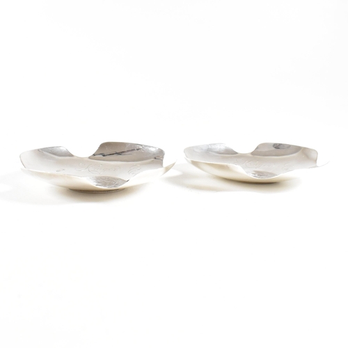 177 - A pair of early 20th century silver pin dishes or ash trays. The dishes containing Kruger coinage to... 